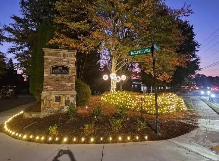 Subdivision entrance monument with pathway lights, shrub nets and light spheres